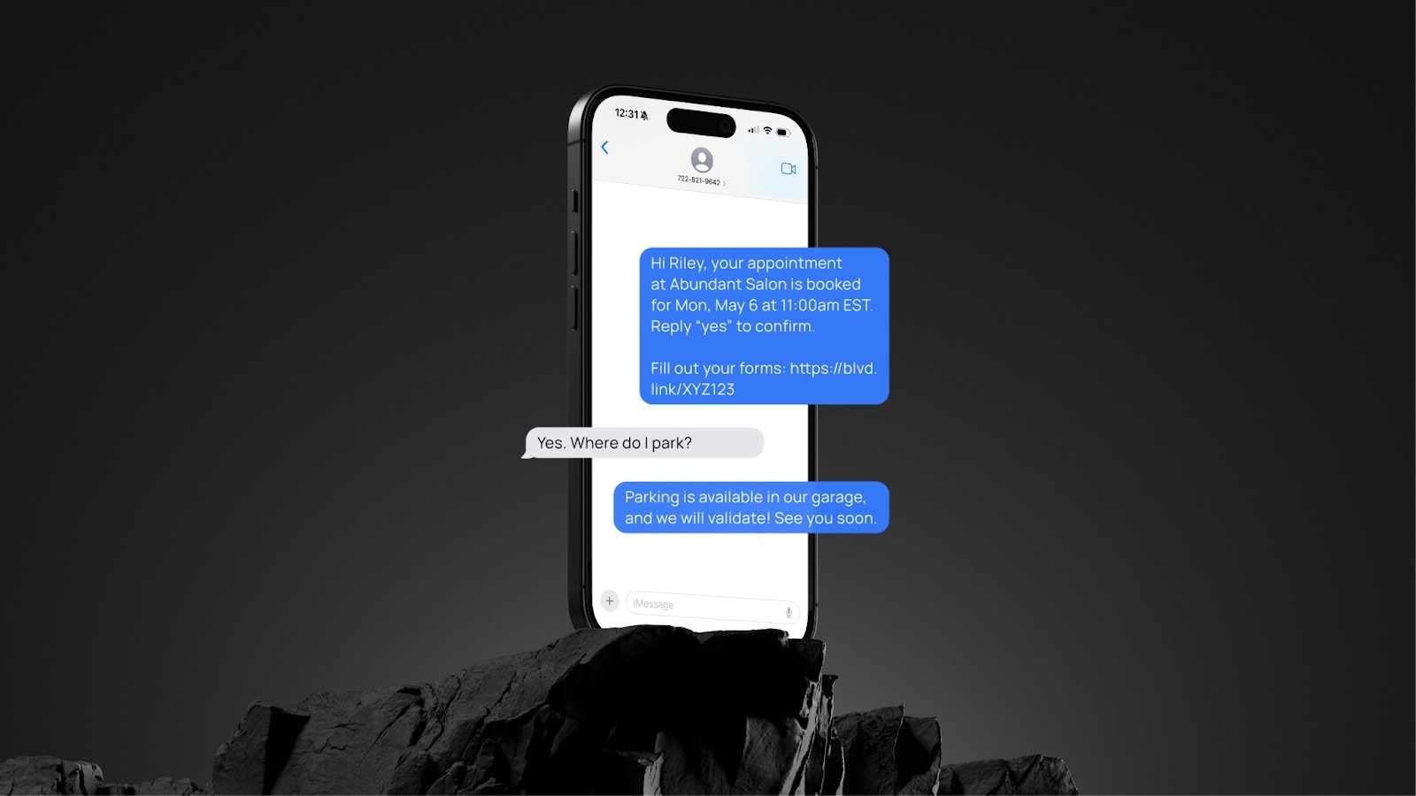Messages popping off of an iPhone standing up against a dark background on black rocks. 