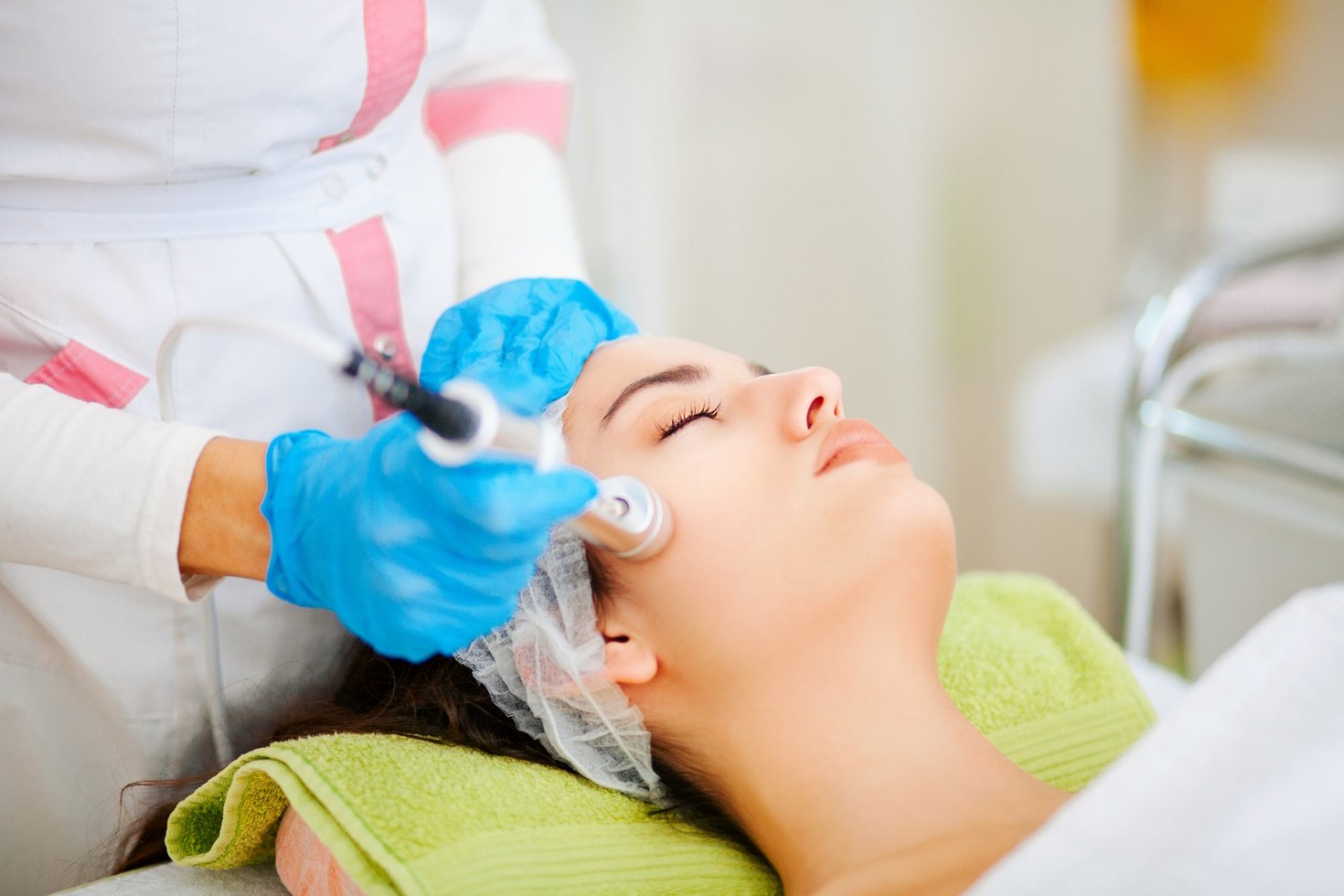 Patient receives microdermabrasion treatment on her face at a MedSpa.