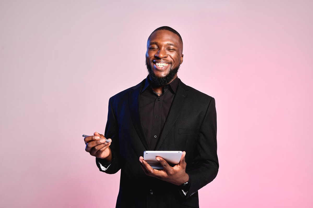 A spa owner reviews a spa service menu on a tablet.