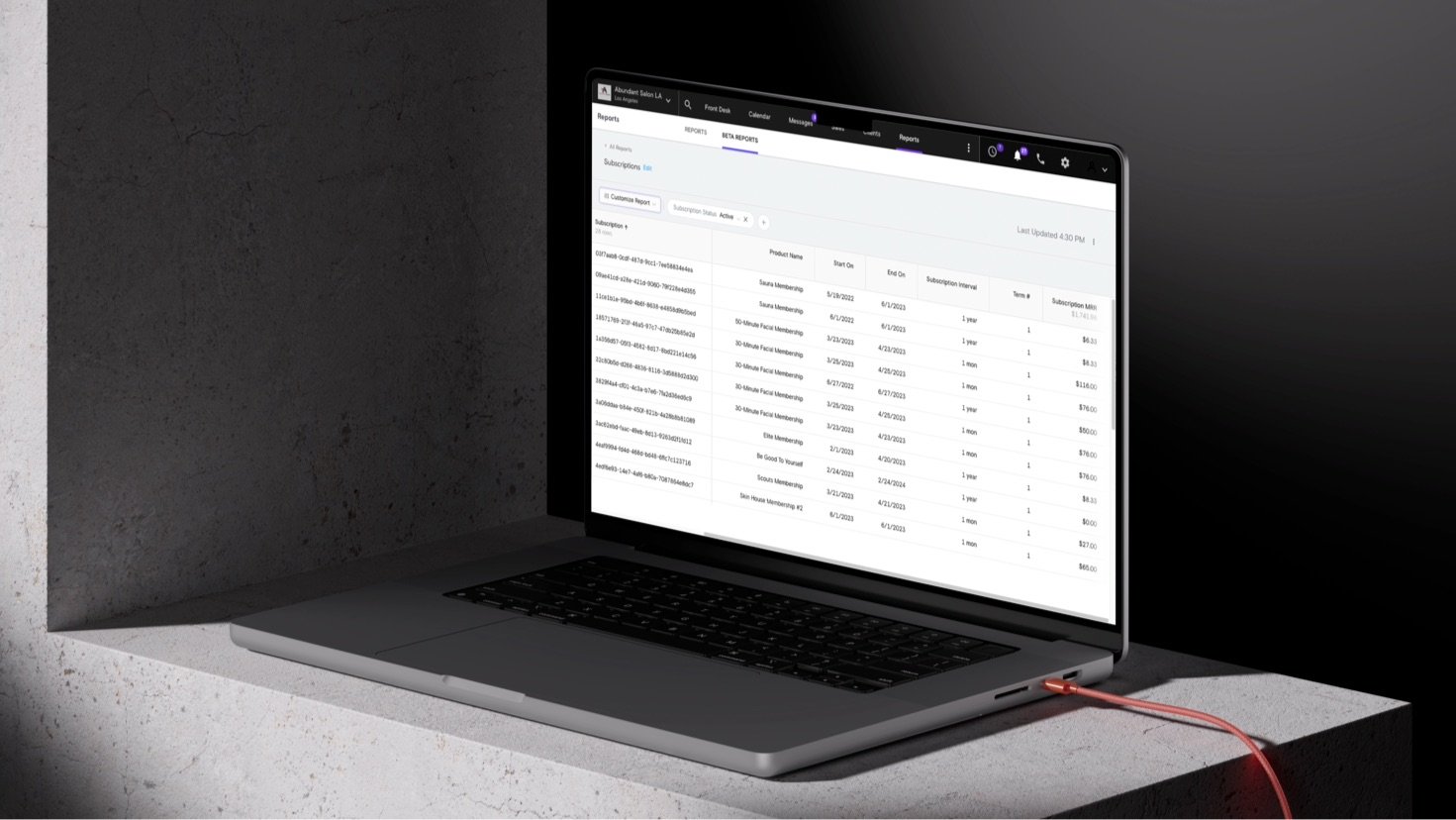 Silver laptop on a countertop displaying a report created using Boulevard software.
