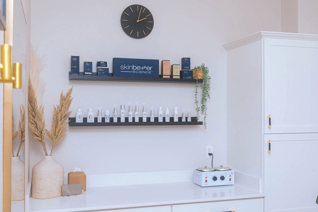 Rows of shelves lined with skin care products line a wall at a medspa.